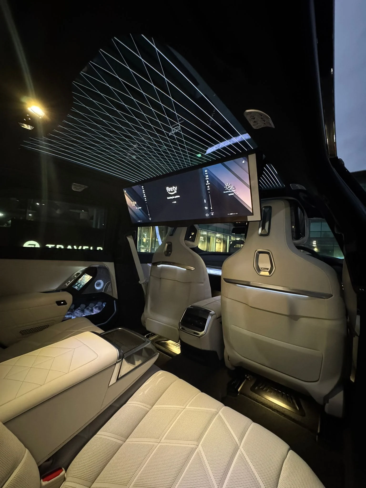 BMW i7 luxury electric chauffeur saloon rear cabin showing 31.3 inch theatre entertainment display and Sky Lounge roof