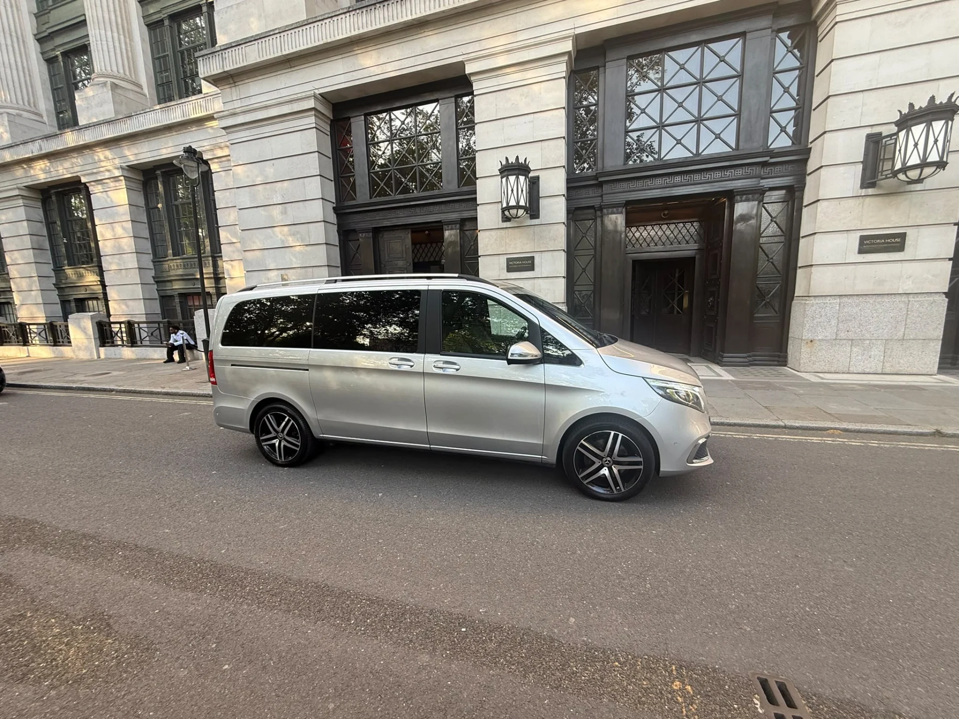Silver Mercedes-Benz V-Class chauffeur vehicle outside Victoria House in Bloomsbury London
